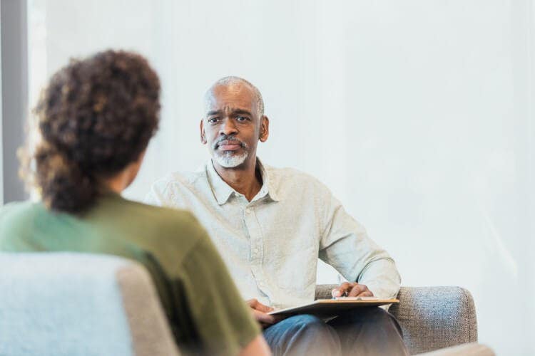 A counselor listens to a client.